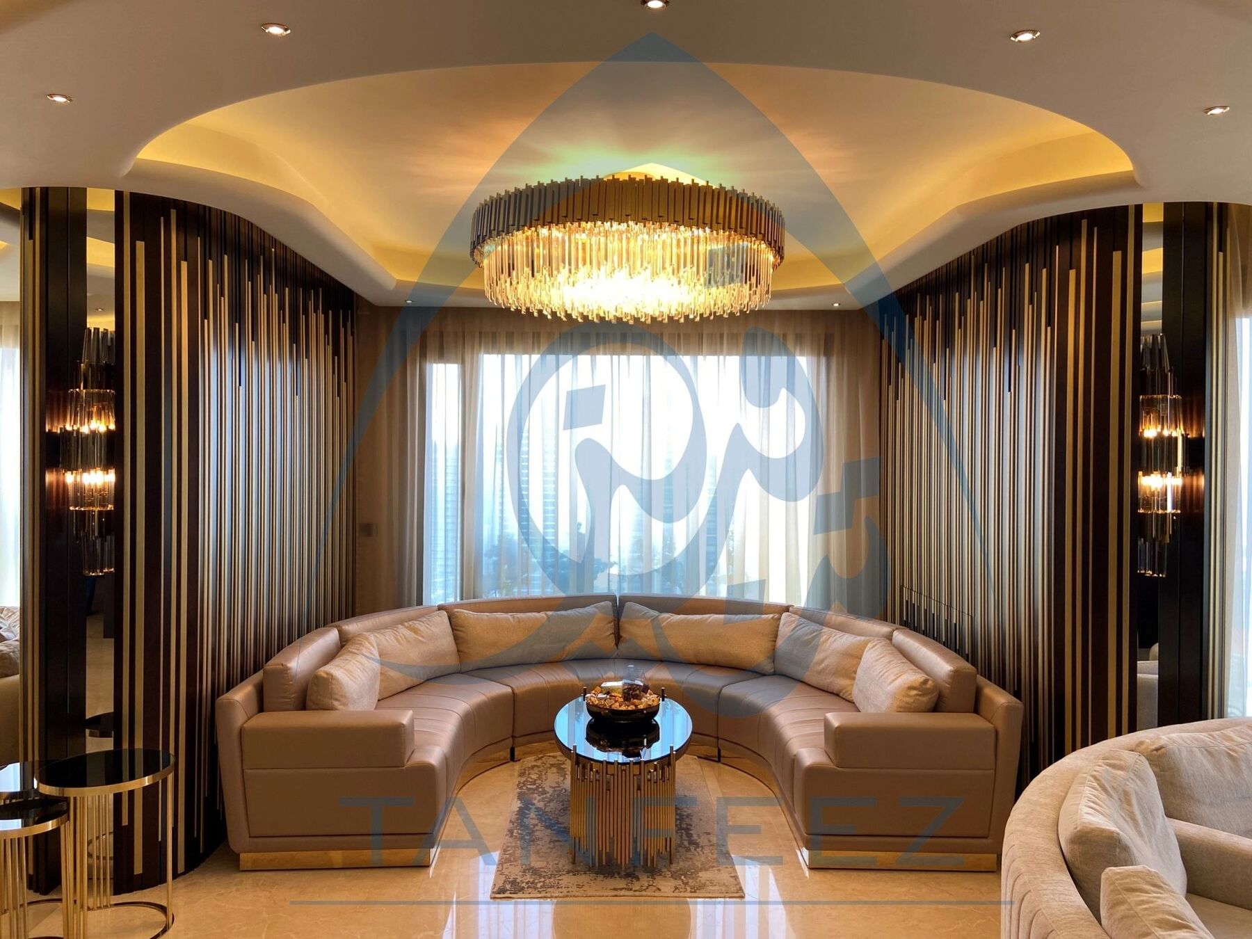 Lounge with a curved sofa under a round crystal chandelier