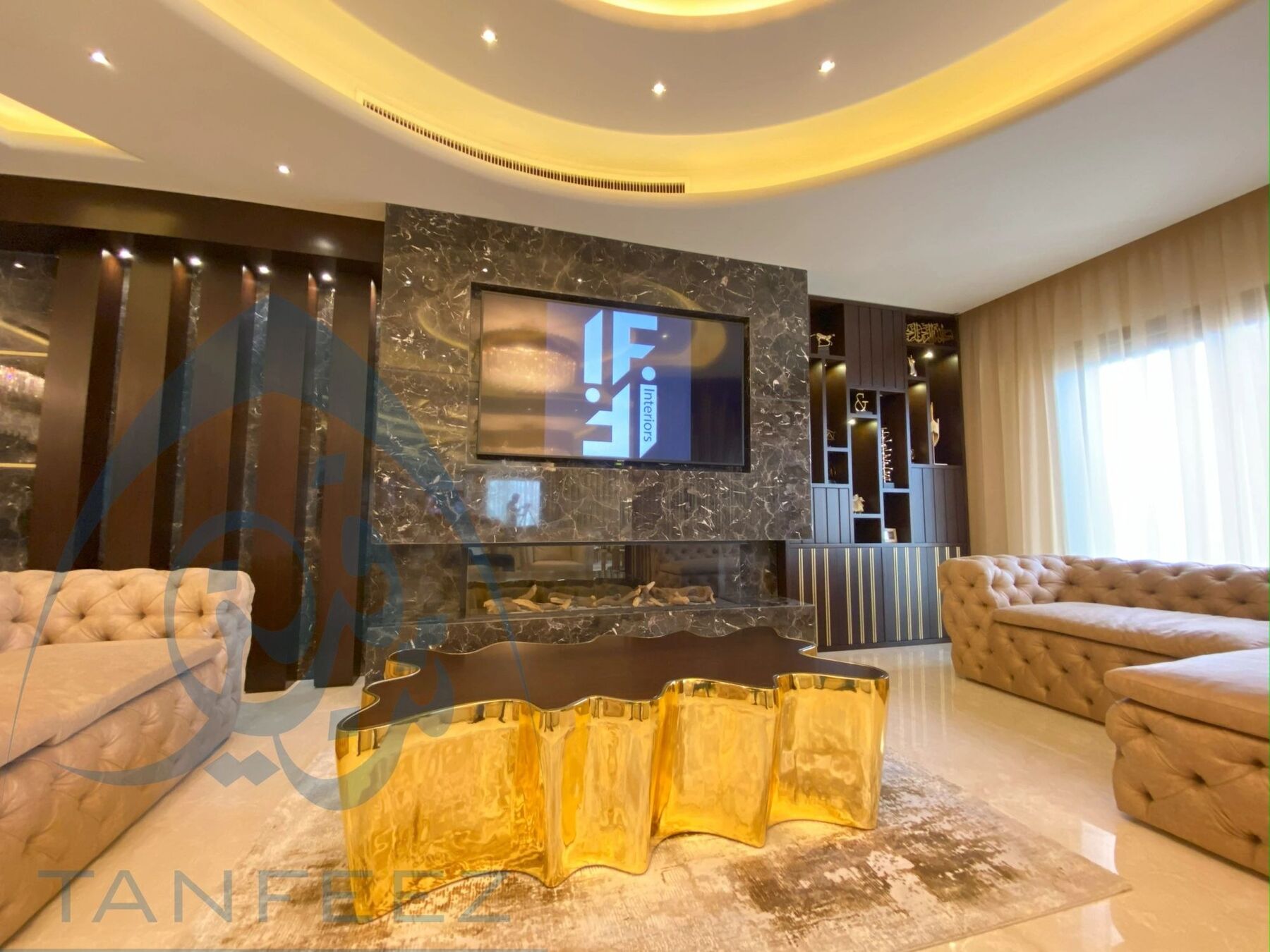 Living room with a marble fireplace wall and gold coffee table