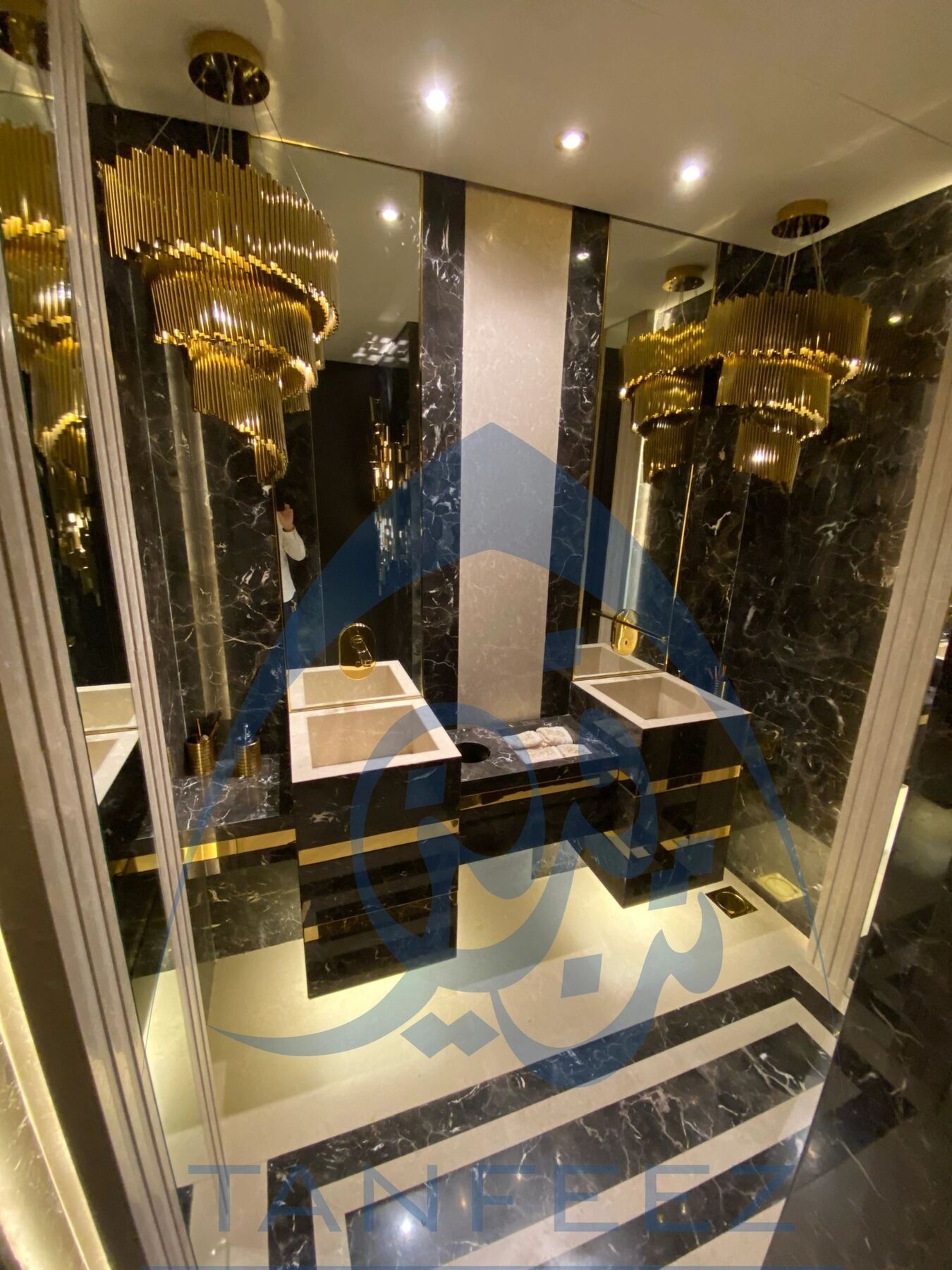 Bathroom in black marble with gold fittings