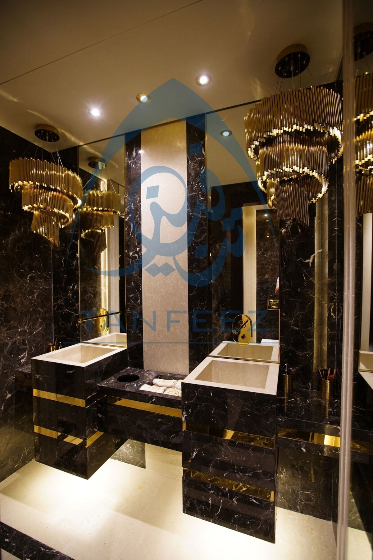 Bathroom with twin marble vanities and gold lights